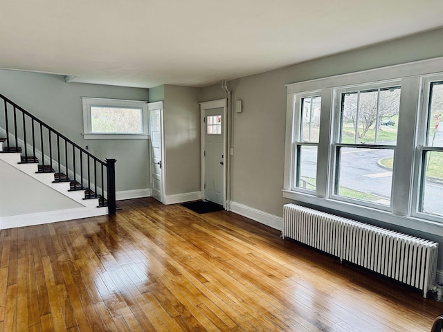 foyer featuring light hardwood / wood-style flooring, radiator, and plenty of natural light