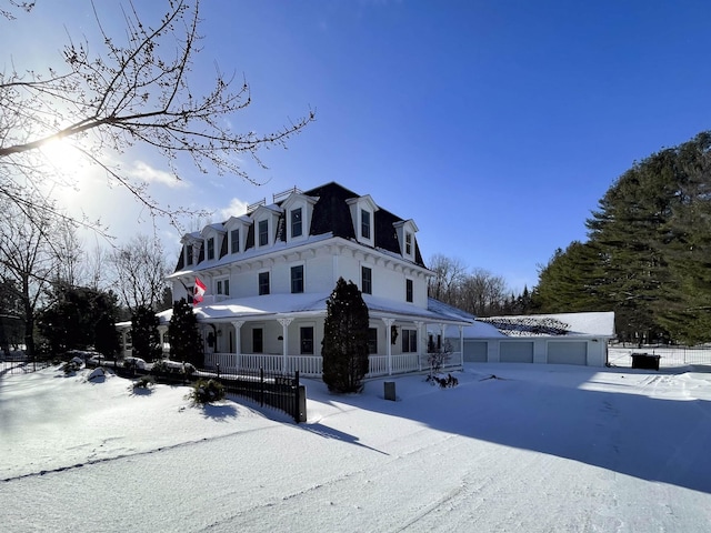 view of front facade with covered porch and a garage