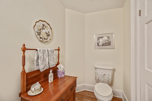 bathroom with wood-type flooring and toilet