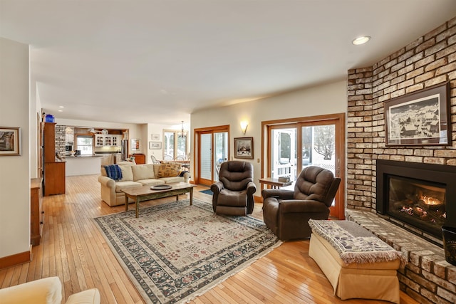 living room featuring light wood-type flooring and a fireplace