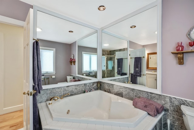 full bathroom with separate shower and tub, vanity, and toilet