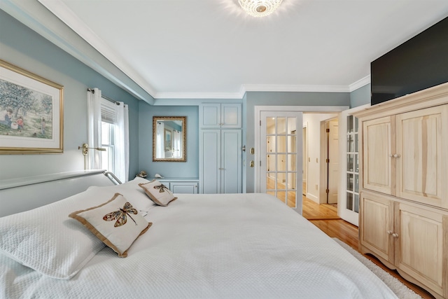 bedroom featuring light wood-type flooring and ornamental molding