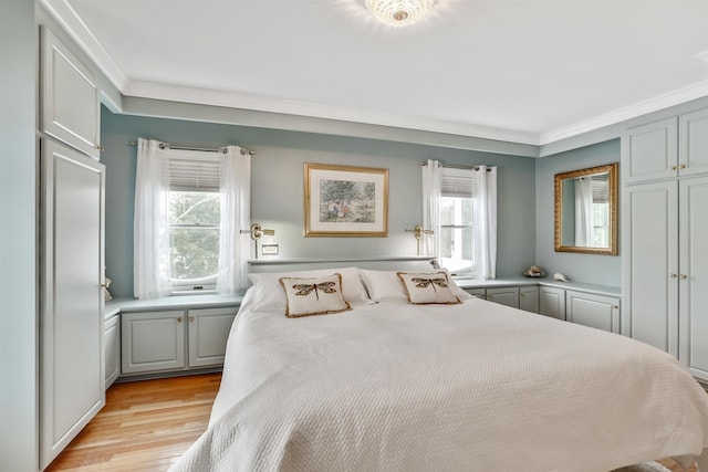 bedroom with light hardwood / wood-style floors and crown molding