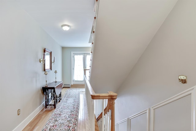 interior space featuring french doors, a baseboard radiator, and light hardwood / wood-style floors