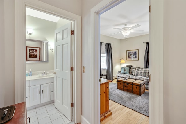 corridor with sink and light hardwood / wood-style floors