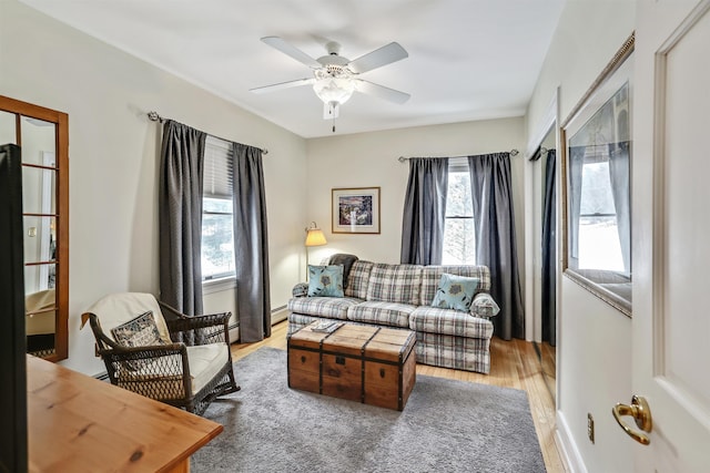 living room featuring light hardwood / wood-style floors and ceiling fan