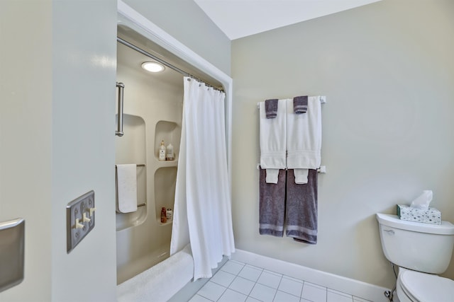 bathroom featuring tile patterned flooring, a shower with curtain, and toilet