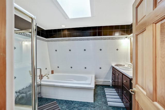 bathroom with vanity, tile patterned floors, separate shower and tub, baseboard heating, and tile walls