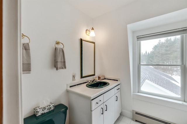 bathroom with tile patterned flooring, vanity, plenty of natural light, and baseboard heating