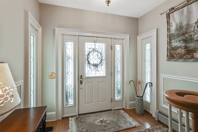 entryway featuring light wood-type flooring and a baseboard heating unit