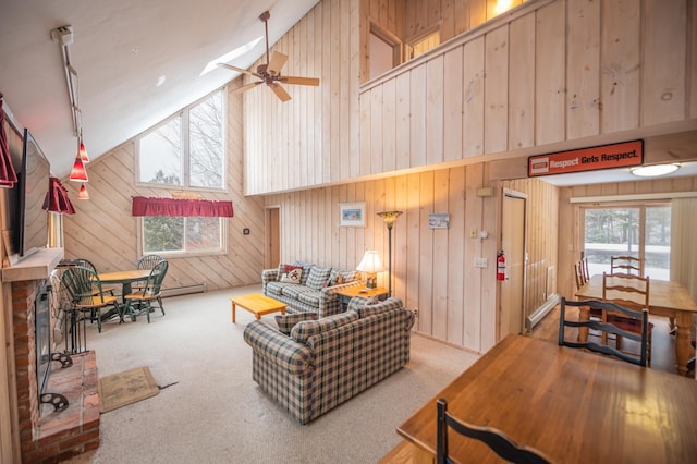 living room featuring carpet, ceiling fan, a healthy amount of sunlight, and high vaulted ceiling