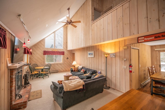 carpeted living room featuring a baseboard radiator, high vaulted ceiling, ceiling fan, and wooden walls