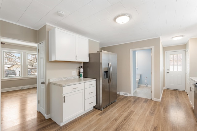 kitchen with crown molding, light hardwood / wood-style flooring, white cabinets, and stainless steel refrigerator with ice dispenser