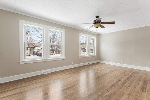 spare room featuring ceiling fan, plenty of natural light, and hardwood / wood-style flooring