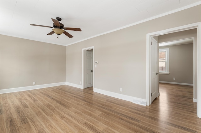 spare room with hardwood / wood-style flooring, ceiling fan, and crown molding