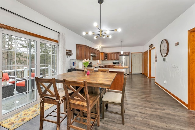 dining room with dark hardwood / wood-style flooring and an inviting chandelier