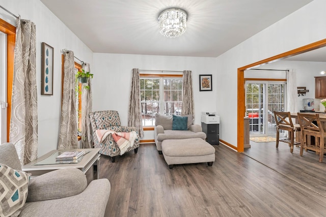 living area with hardwood / wood-style flooring and a notable chandelier