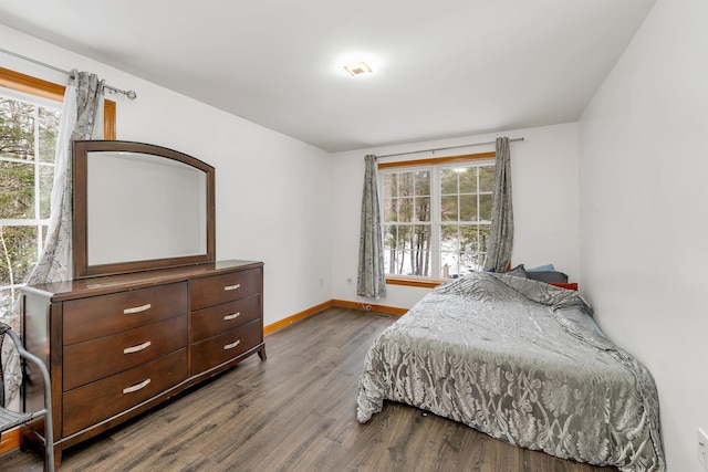 bedroom with wood-type flooring and multiple windows