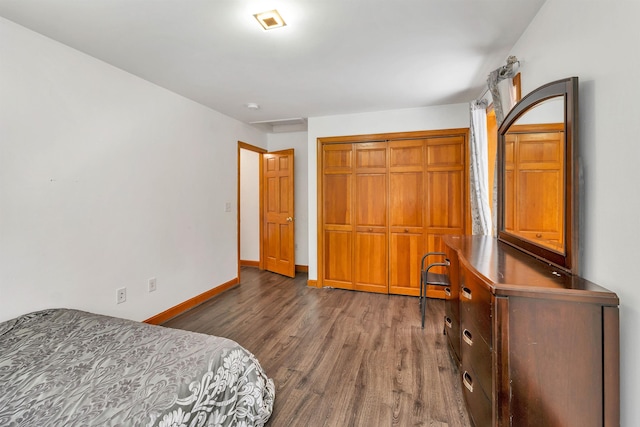 bedroom featuring a closet and dark wood-type flooring