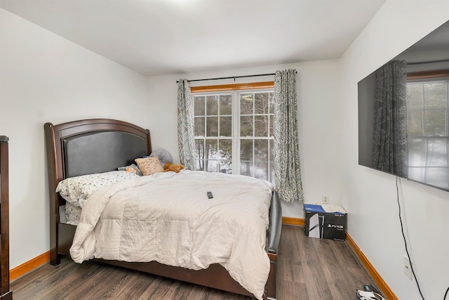 bedroom with dark hardwood / wood-style flooring