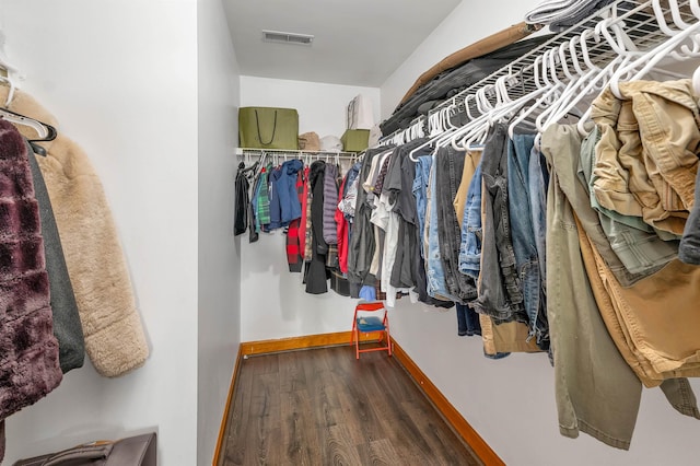 walk in closet featuring dark hardwood / wood-style floors