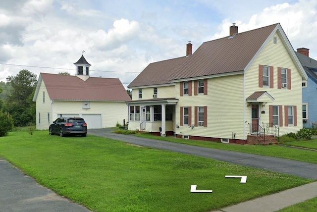 view of front of house with a front yard and a garage