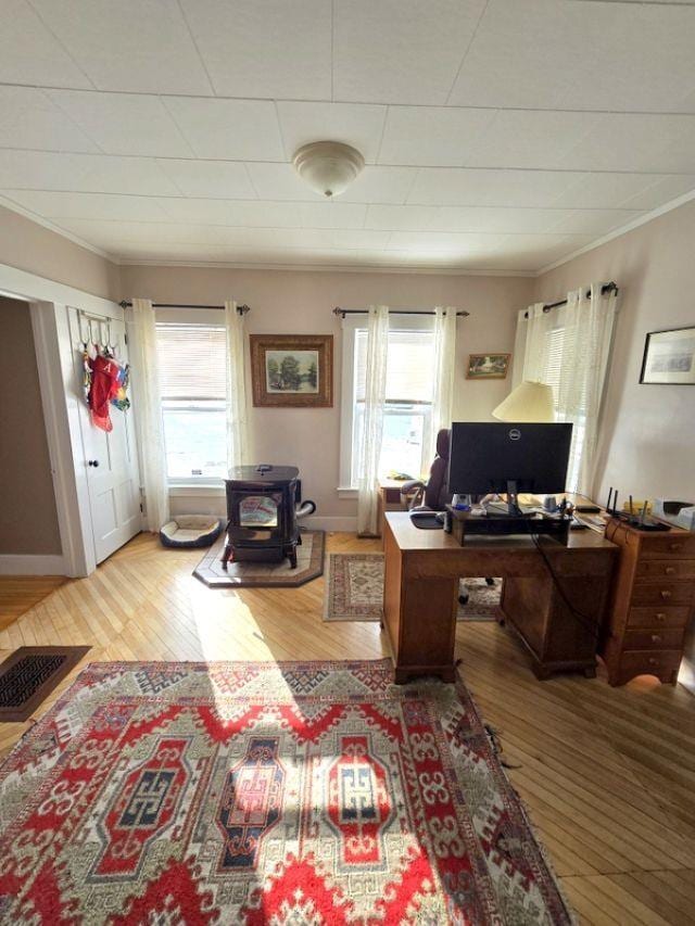 office area with light wood-type flooring and crown molding