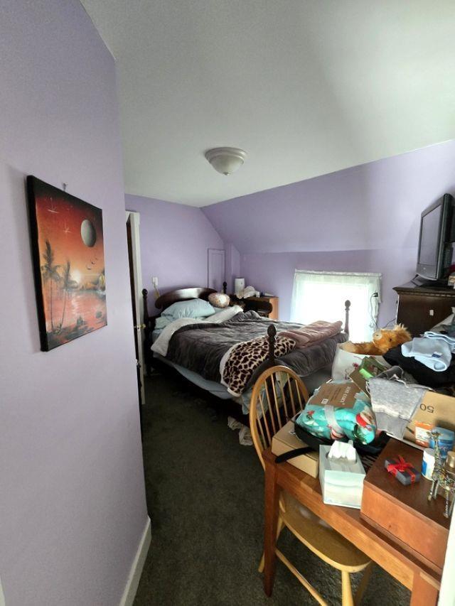 carpeted bedroom with vaulted ceiling