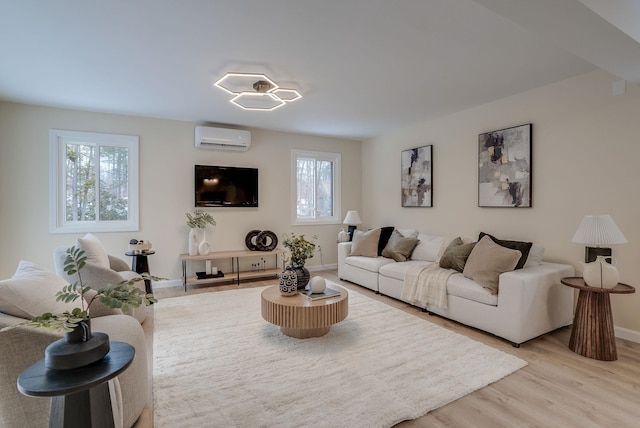 living room featuring light hardwood / wood-style floors and a wall unit AC