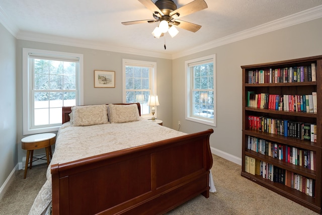 bedroom featuring ceiling fan, crown molding, and light carpet