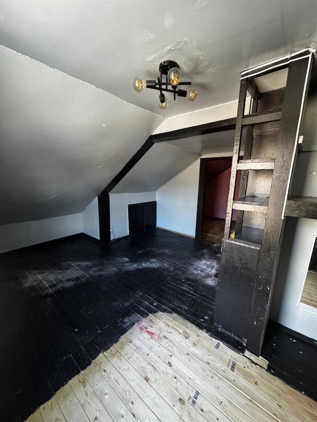 additional living space featuring hardwood / wood-style flooring and lofted ceiling