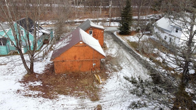 snowy yard featuring an outdoor structure