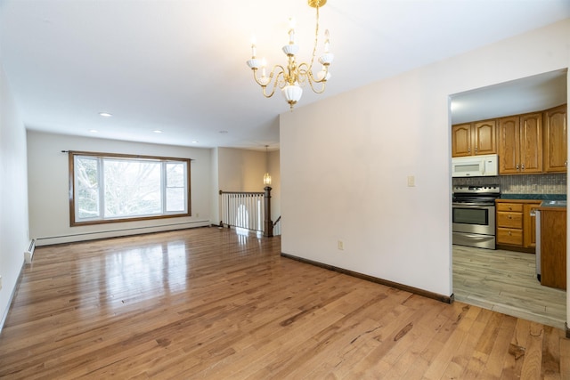 interior space with pendant lighting, stainless steel range with electric cooktop, baseboard heating, a notable chandelier, and light hardwood / wood-style floors