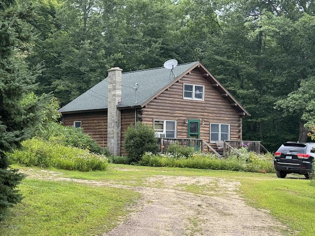 view of front of house featuring a front lawn and a deck