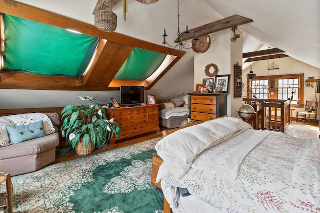 bedroom with hardwood / wood-style floors and vaulted ceiling with skylight