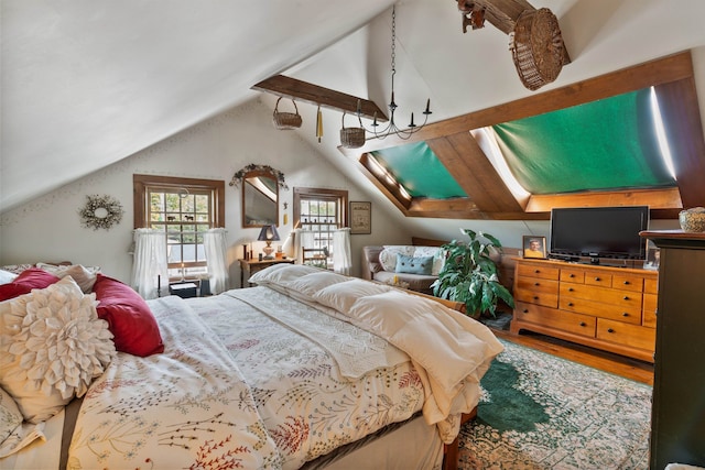 bedroom featuring hardwood / wood-style floors and vaulted ceiling