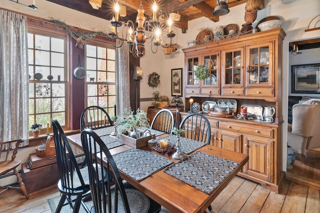 dining area with plenty of natural light, light wood-type flooring, and an inviting chandelier