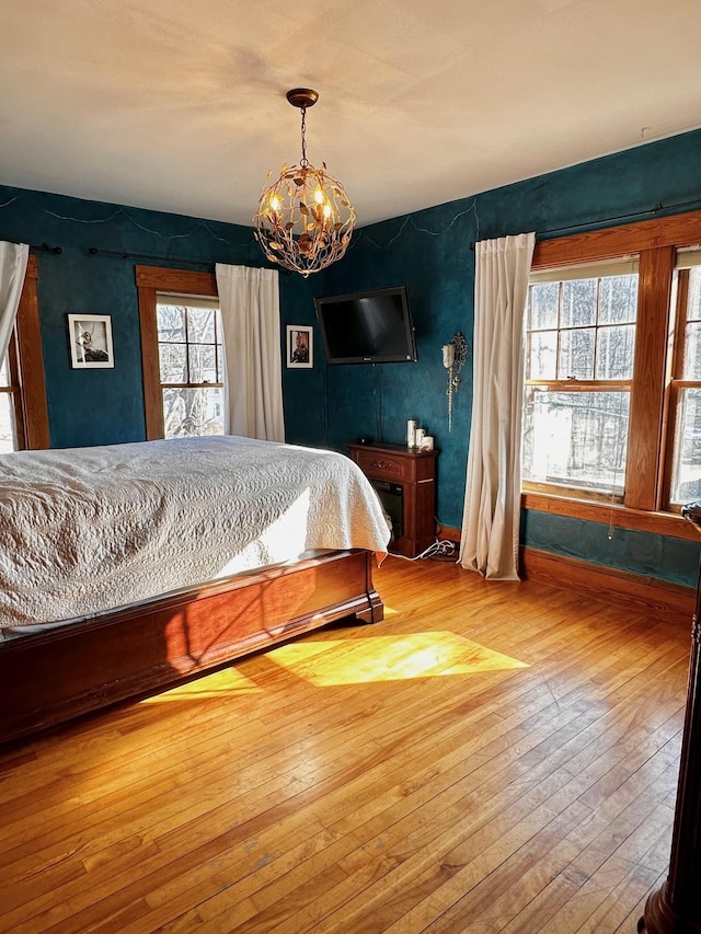 bedroom featuring a notable chandelier and hardwood / wood-style floors