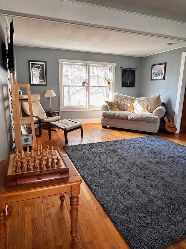 living room featuring hardwood / wood-style floors and beamed ceiling