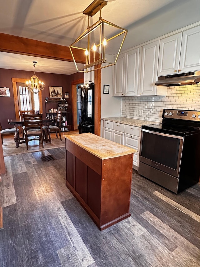 kitchen featuring black refrigerator, hanging light fixtures, a notable chandelier, stainless steel range with electric stovetop, and white cabinets