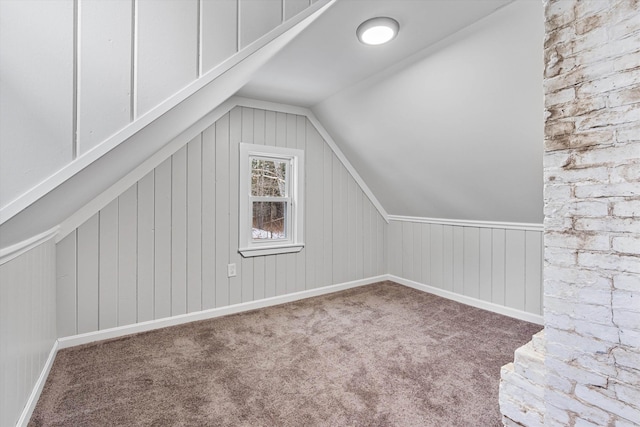 bonus room featuring carpet floors and vaulted ceiling