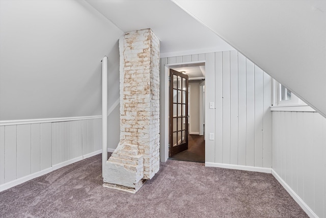 additional living space with carpet floors and vaulted ceiling