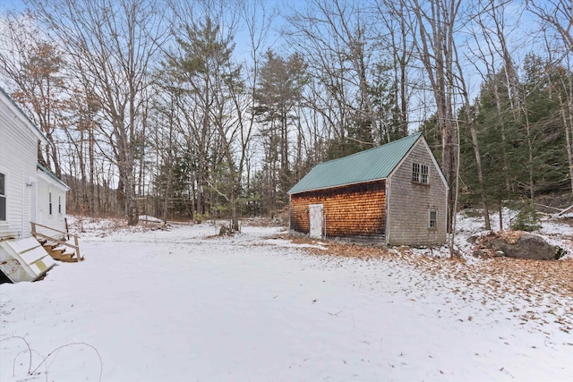 yard layered in snow with an outdoor structure