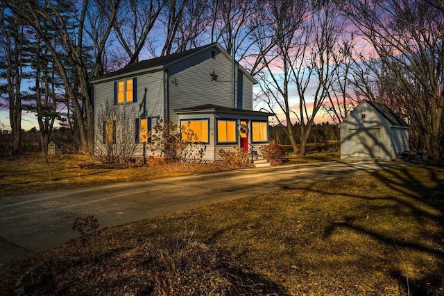 view of front of property featuring a storage shed