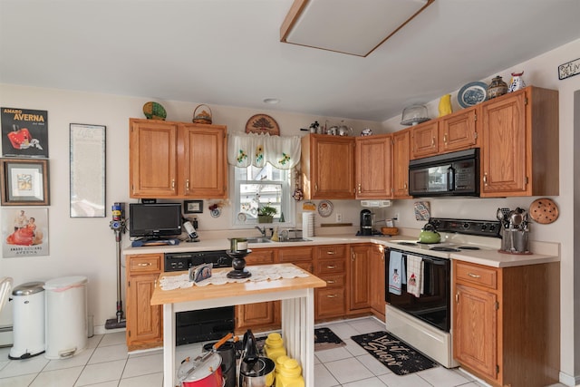 kitchen featuring white range with electric cooktop, light tile patterned floors, and sink