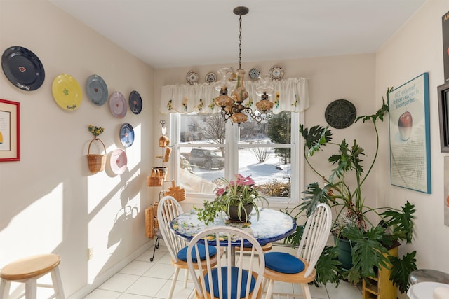 tiled dining area with a chandelier