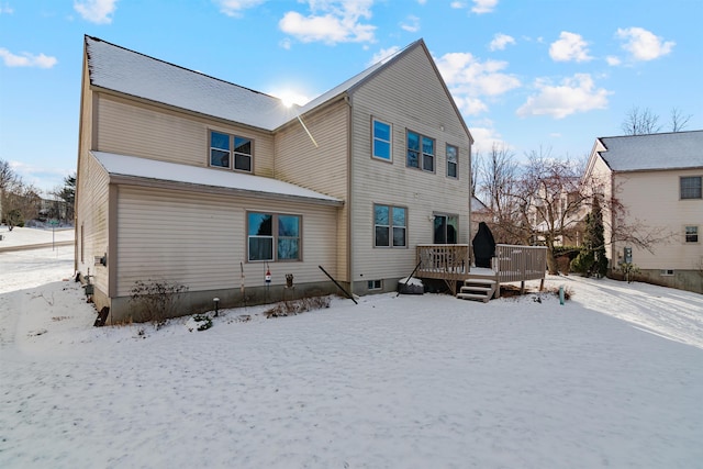 snow covered property featuring a wooden deck