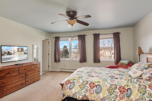 carpeted bedroom featuring baseboard heating and ceiling fan