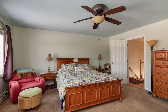 carpeted bedroom with ceiling fan and a baseboard heating unit