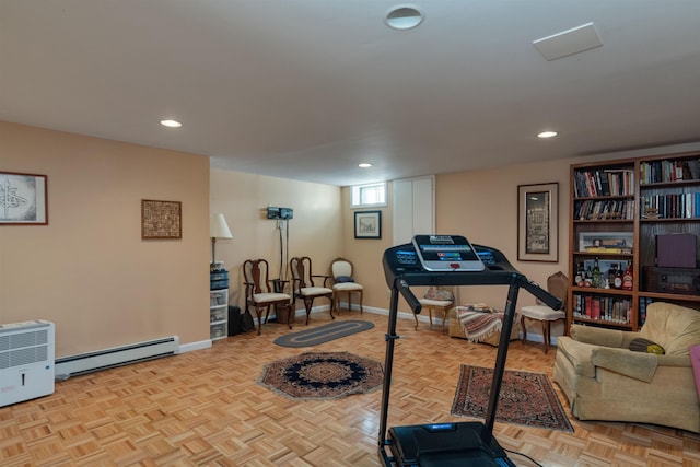 workout area featuring baseboard heating and light parquet floors